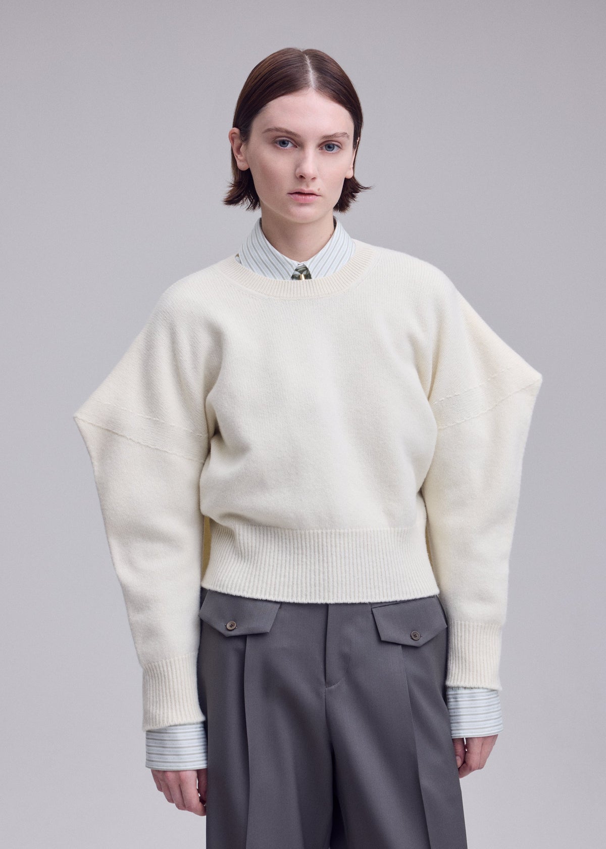 A model wears the ISSEY MIYAKE O KNIT o-knit-top-black.