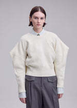 A model wears the ISSEY MIYAKE O KNIT o-knit-top-black.