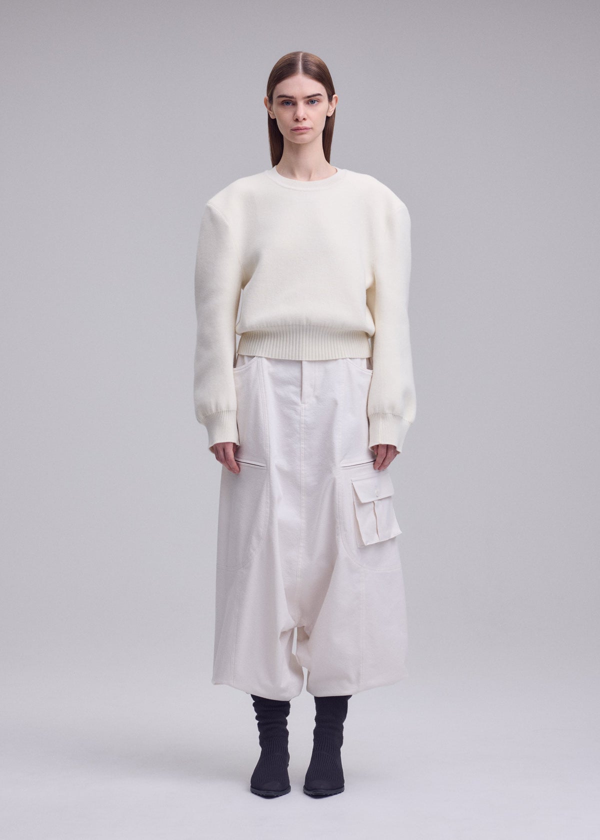 A model wears the ISSEY MIYAKE HANDSOME KNIT handsome-knit-top-off-white.