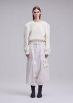 A model wears the ISSEY MIYAKE HANDSOME KNIT handsome-knit-top-black.