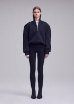 A model wears the ISSEY MIYAKE HANDSOME KNIT handsome-knit-high-neck-top-grey.