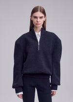 A model wears the ISSEY MIYAKE HANDSOME KNIT handsome-knit-high-neck-top-grey.