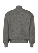 A detail shot of the ISSEY MIYAKE HANDSOME KNIT top.