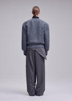 A model wears the ISSEY MIYAKE HANDSOME KNIT handsome-knit-cardigan-black.