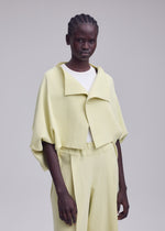 A model wears the ISSEY MIYAKE CAMPAGNE campagne-cardigan-dark-navy.