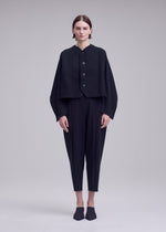 A model wears the ISSEY MIYAKE CAMPAGNE campagne-button-front-cardigan-dark-navy.