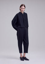 A model wears the ISSEY MIYAKE CAMPAGNE campagne-button-front-cardigan-dark-navy.