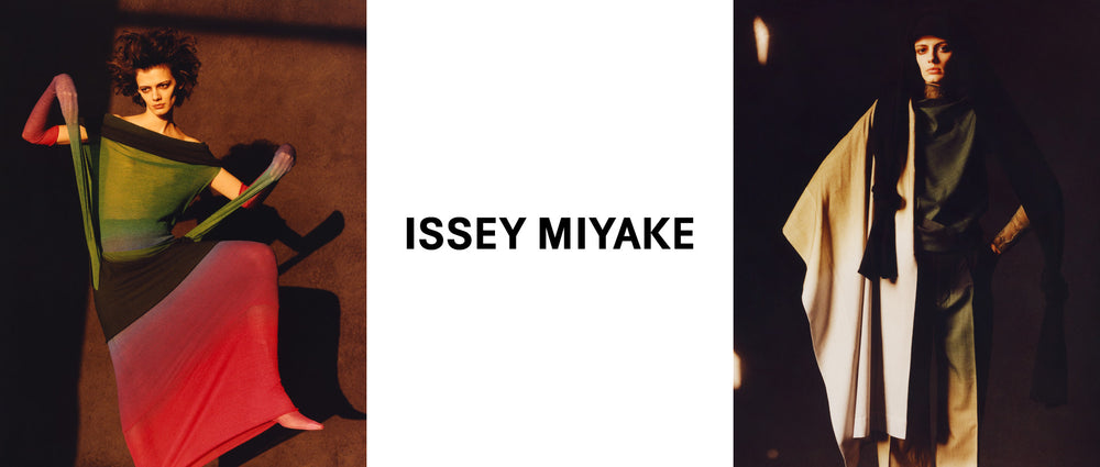 Centre image: ISSEY MIYAKE logo in black writing on a white background. Left image: Model wearing NUANCE TUBE Skirt in Afternoon as a dress, dynamic pose with left knee in the air. Yellow lighting. Brown background. Right image: Model wearing NUANCE Top and Trousers in Before Midnight. Brown background.