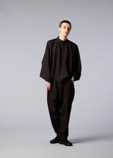 A model wears the IM MEN BREEZE trousers.