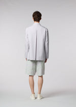 A model wears the ISSEY MIYAKE MEN WINGS jacket.