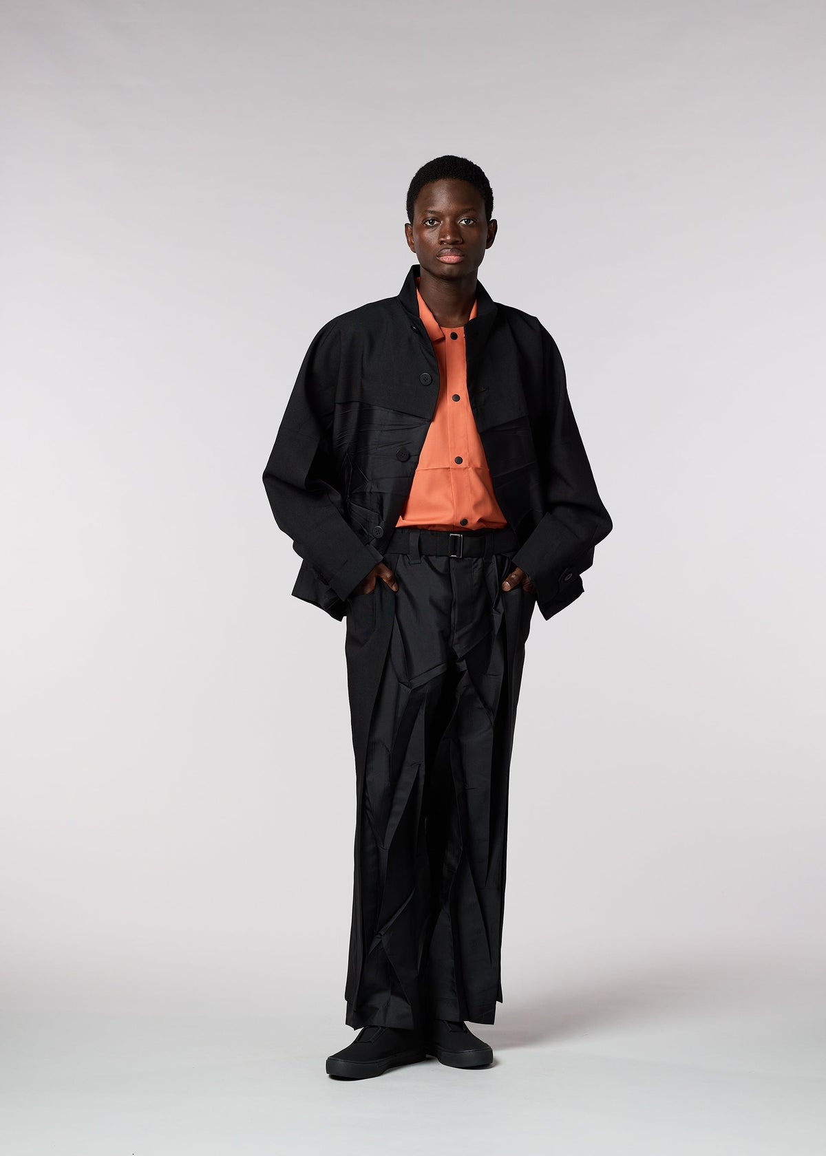 A model wears the IM MEN HIDING trousers.