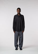 A model wears the IM MEN FLAT trousers.