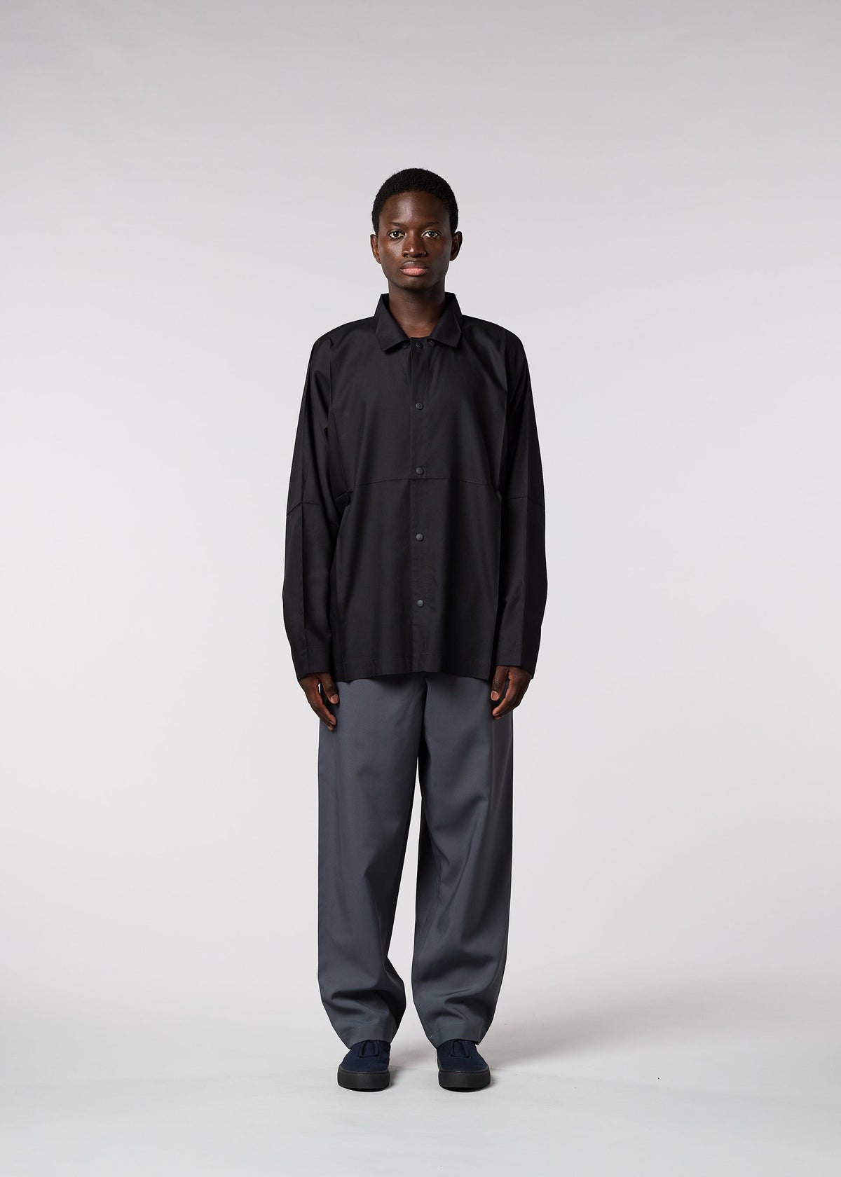 A model wears the IM MEN FLAT trousers.