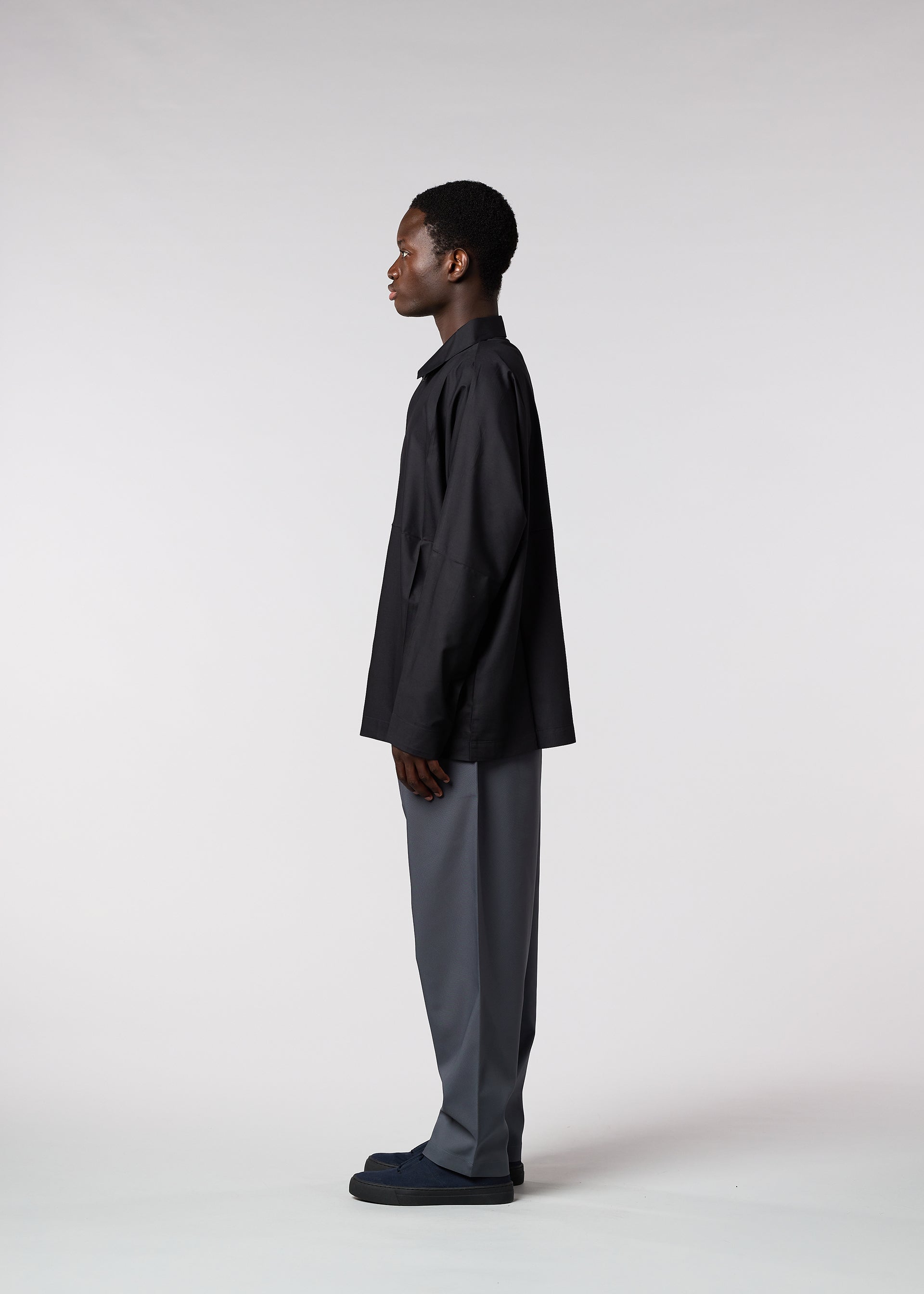 A model wears the IM MEN FLAT trousers.