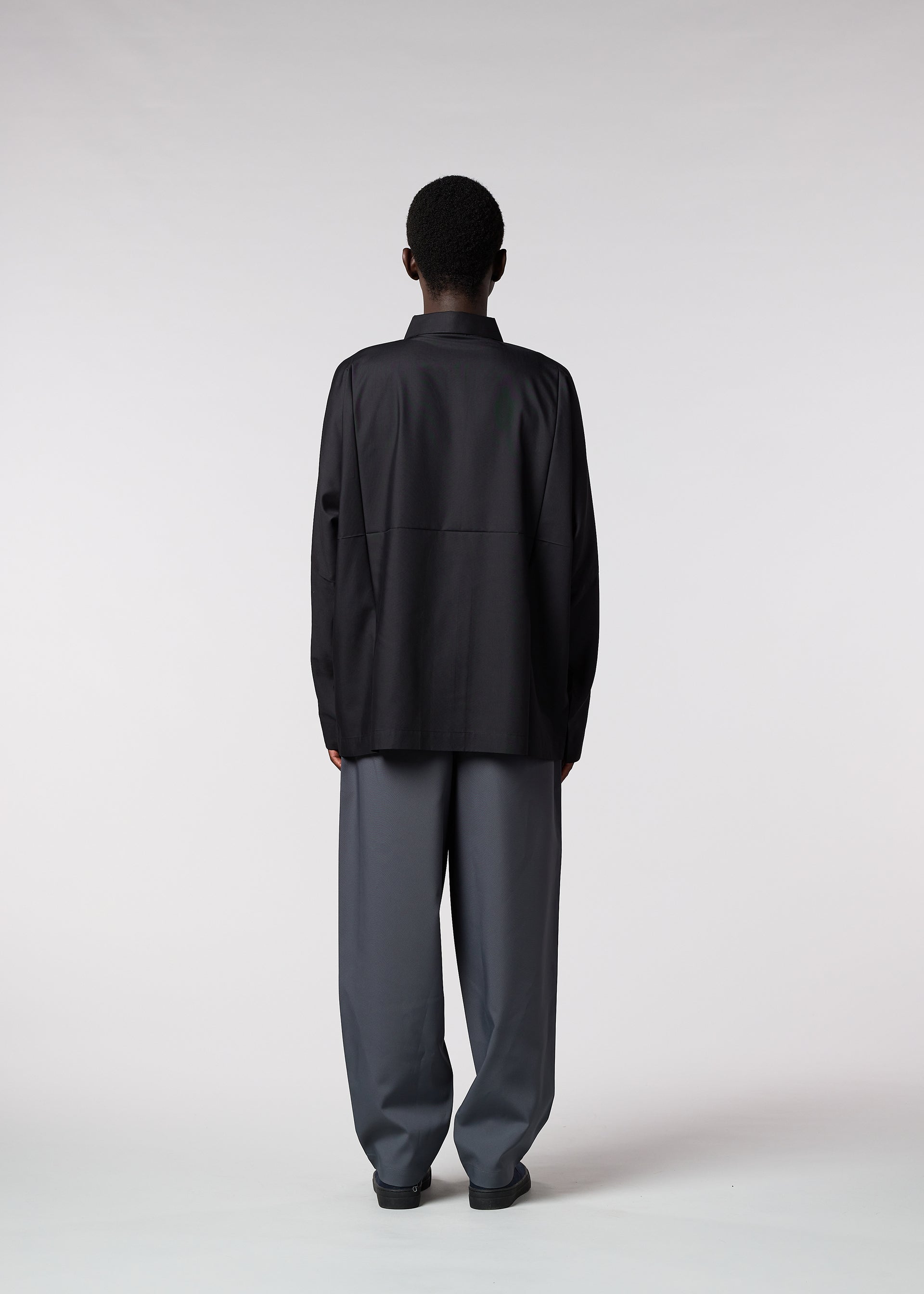 A model wears the IM MEN FLAT trousers.