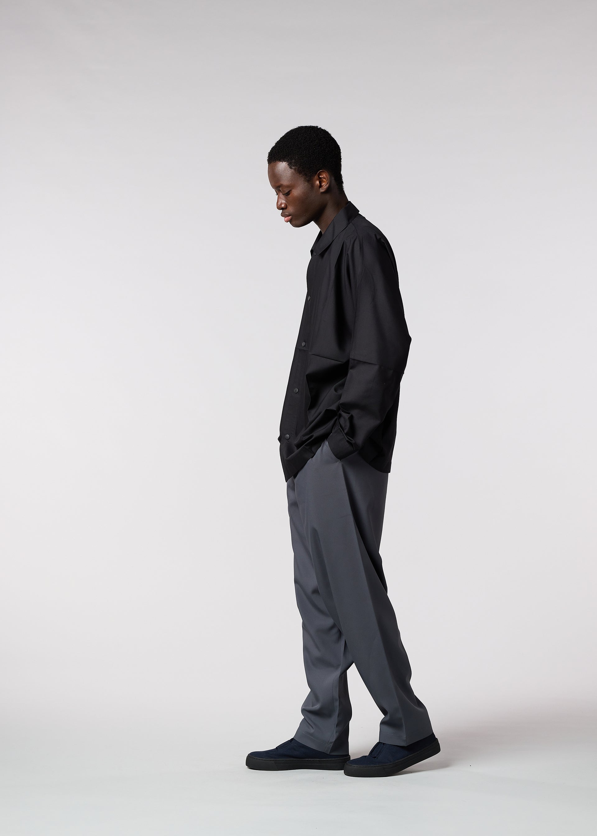 A model wears the IM MEN FLAT trousers.