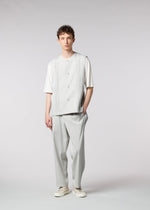 A model wears the IM MEN AIR PLEATS trousers.