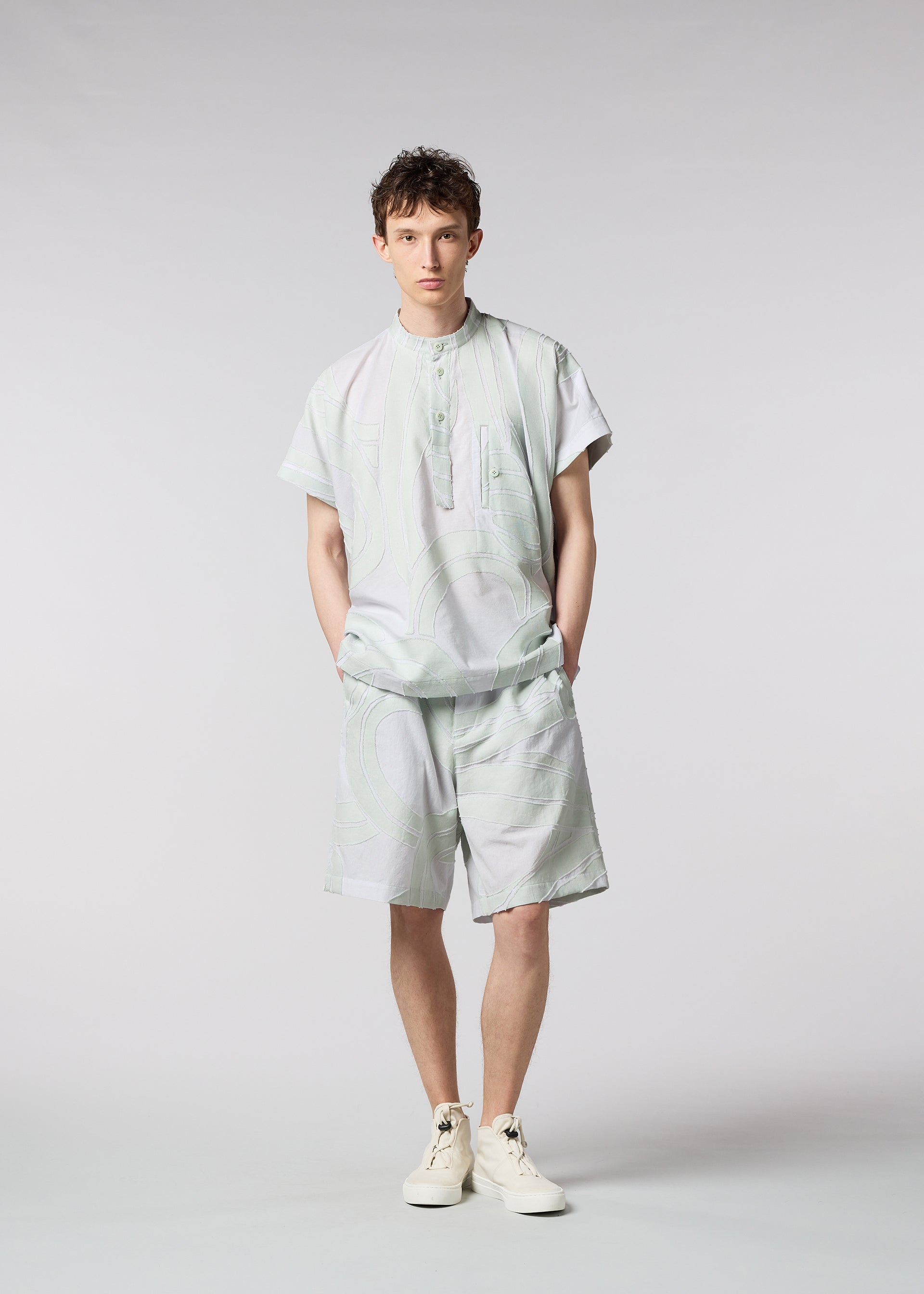 A model wears the ISSEY MIYAKE MEN SCENES trousers.