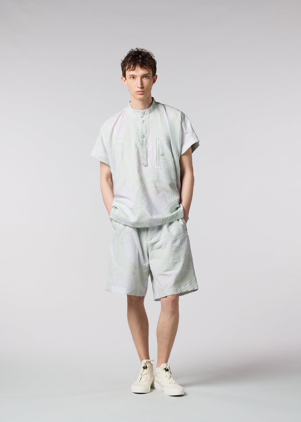 A model wears the ISSEY MIYAKE MEN SCENES trousers.