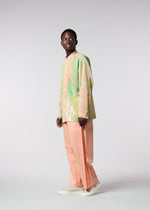 A model wears the ISSEY MIYAKE MEN WINGS trousers.