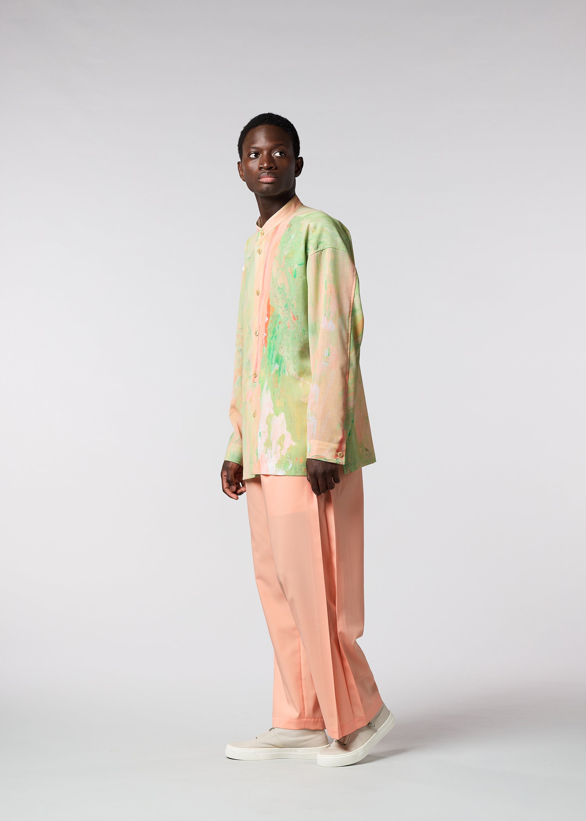 A model wears the ISSEY MIYAKE MEN WINGS trousers.