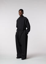 A model wears the ISSEY MIYAKE MEN WINGS jumpsuit.
