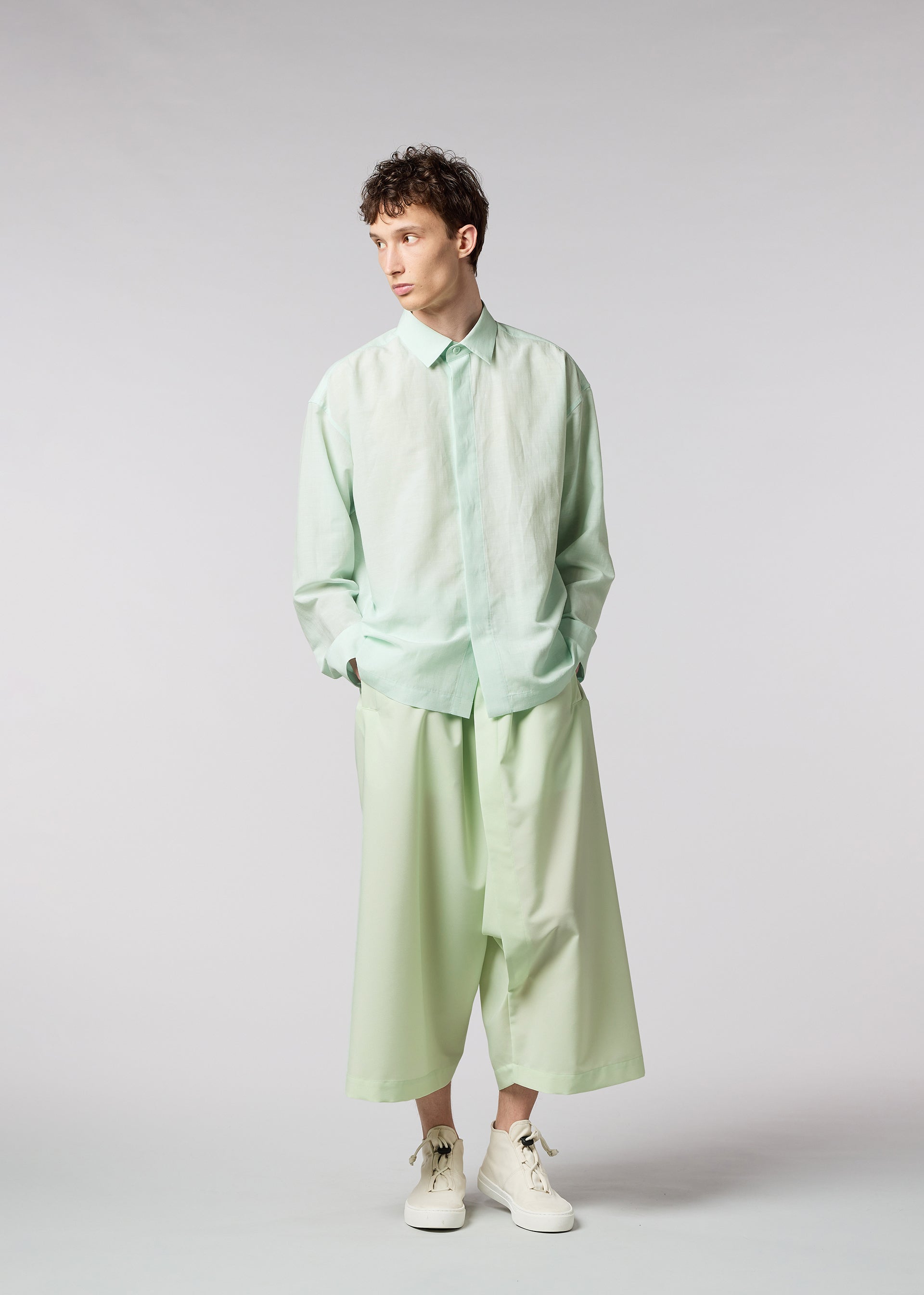 A model wears the IM MEN HYBRID SHIRT shirt.