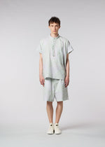 A model wears the ISSEY MIYAKE MEN SCENES shirt.