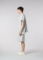 A model wears the ISSEY MIYAKE MEN SCENES shirt.