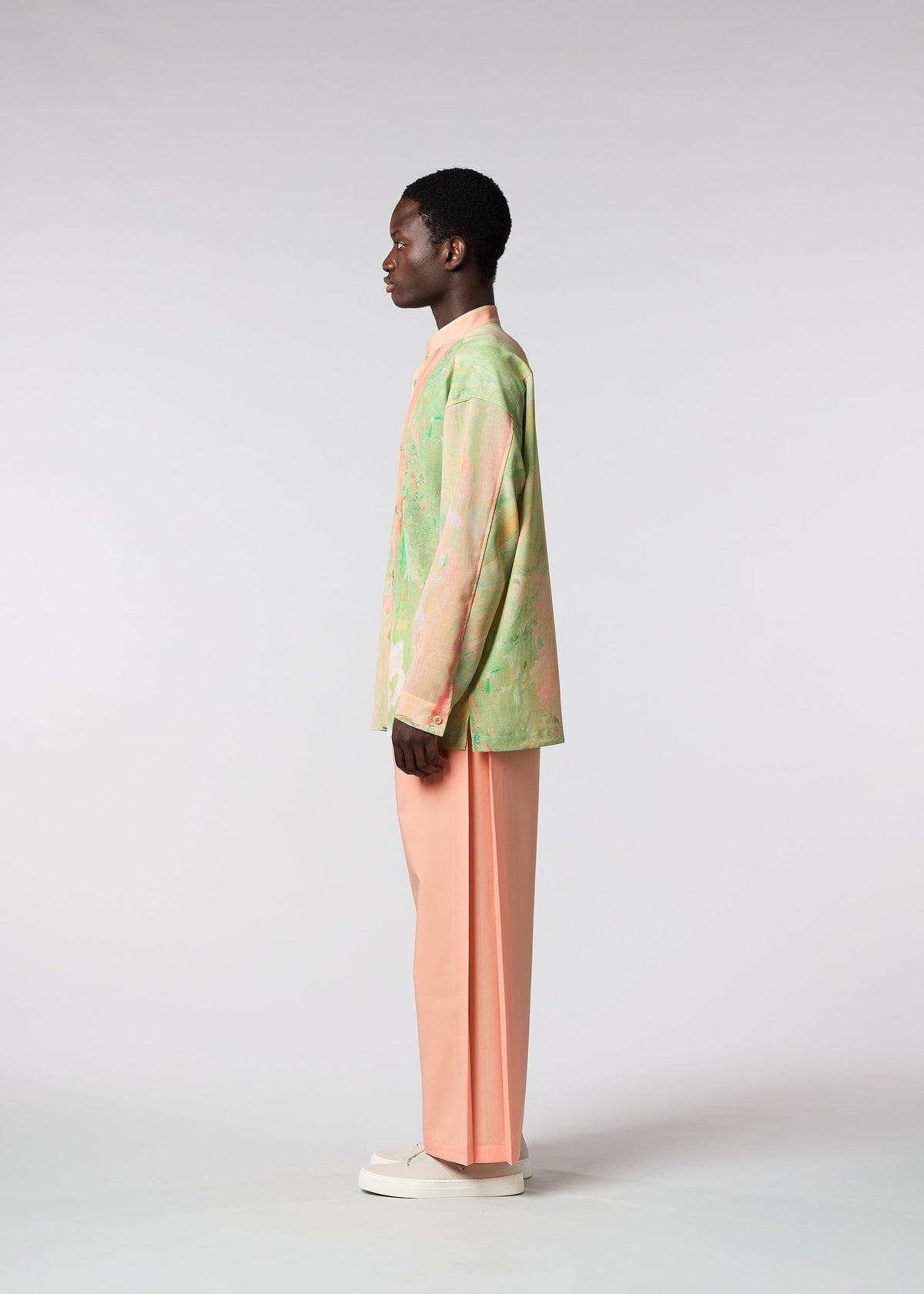 A model wears the ISSEY MIYAKE MEN BY CHANCE shirt.