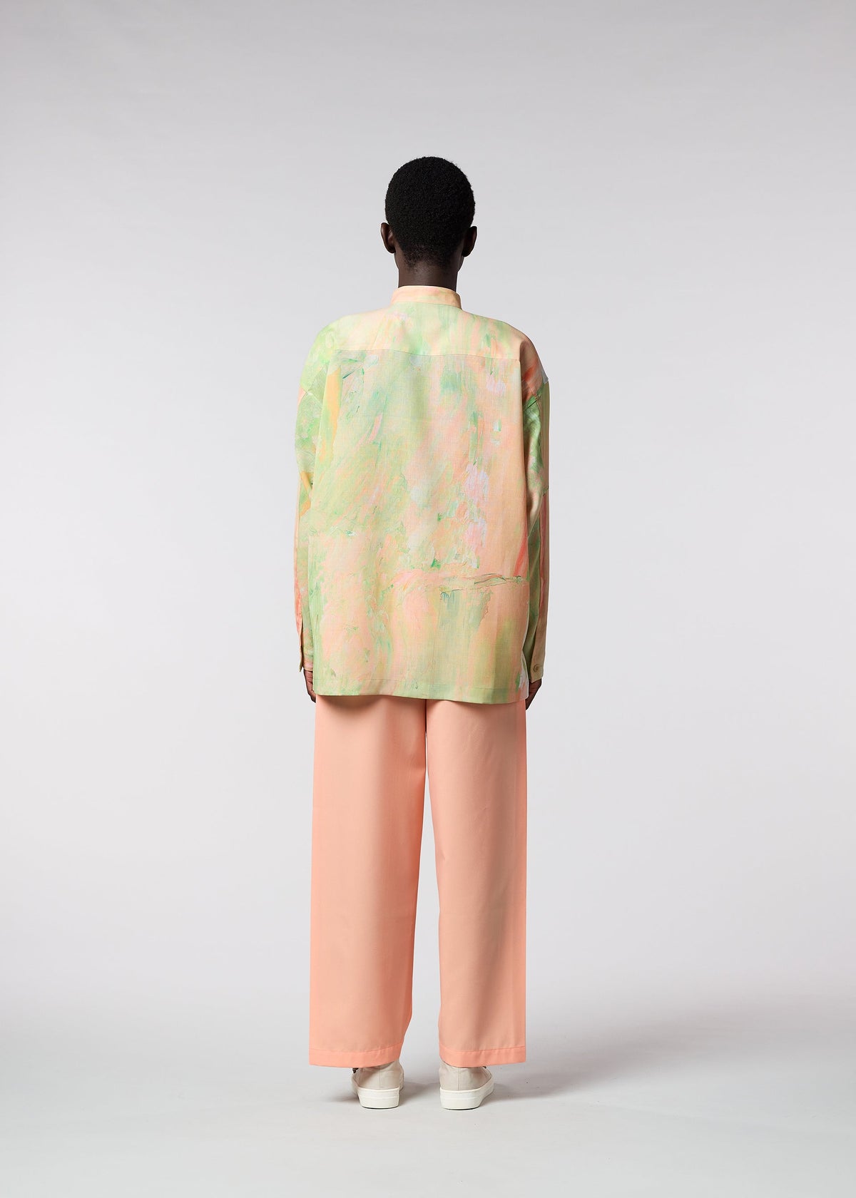 A model wears the ISSEY MIYAKE MEN BY CHANCE shirt.