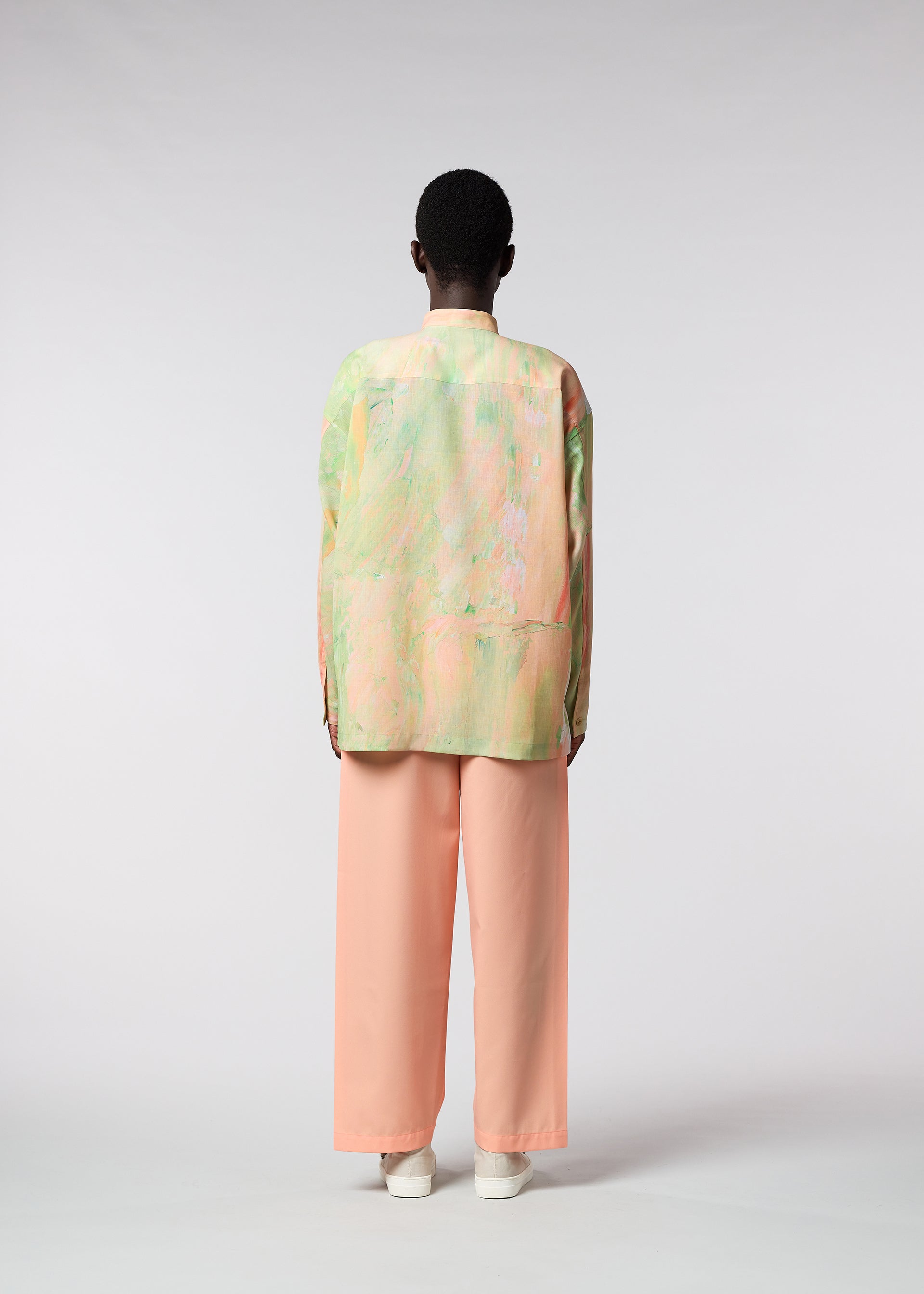 A model wears the ISSEY MIYAKE MEN BY CHANCE shirt.