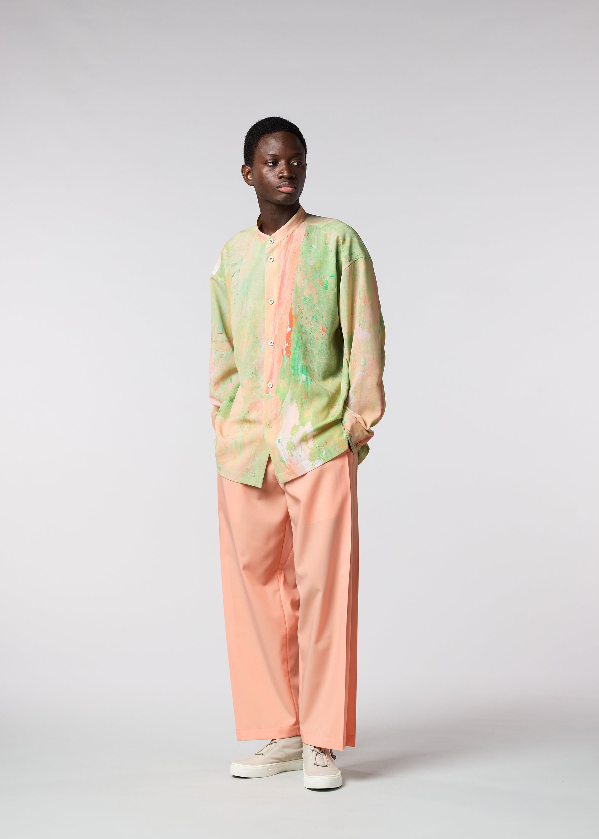 A model wears the ISSEY MIYAKE MEN BY CHANCE shirt.