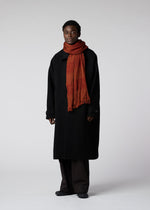 A model wears the IM MEN WOOL TUCK STOLE stole.