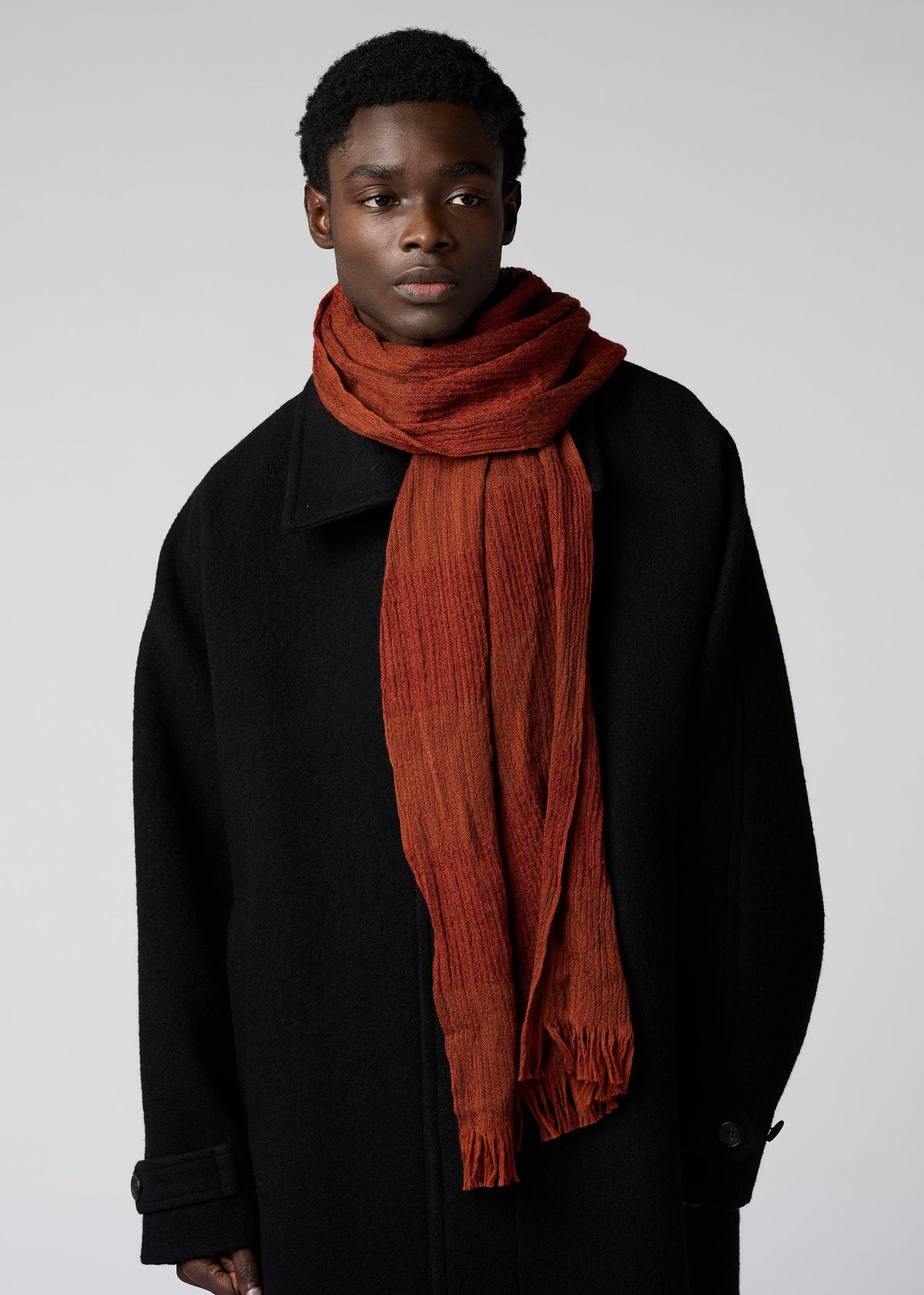 A model wears the IM MEN WOOL TUCK STOLE stole.