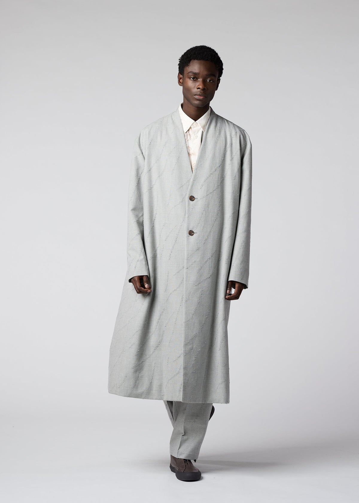 A model wears the IM MEN FLY WOOL coat.
