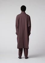 A model wears the IM MEN FLAT clothing.