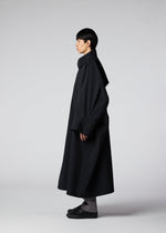 A model wears the IM MEN WIND COAT LIGHT clothing.