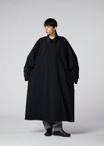 A model wears the IM MEN WIND COAT LIGHT clothing.