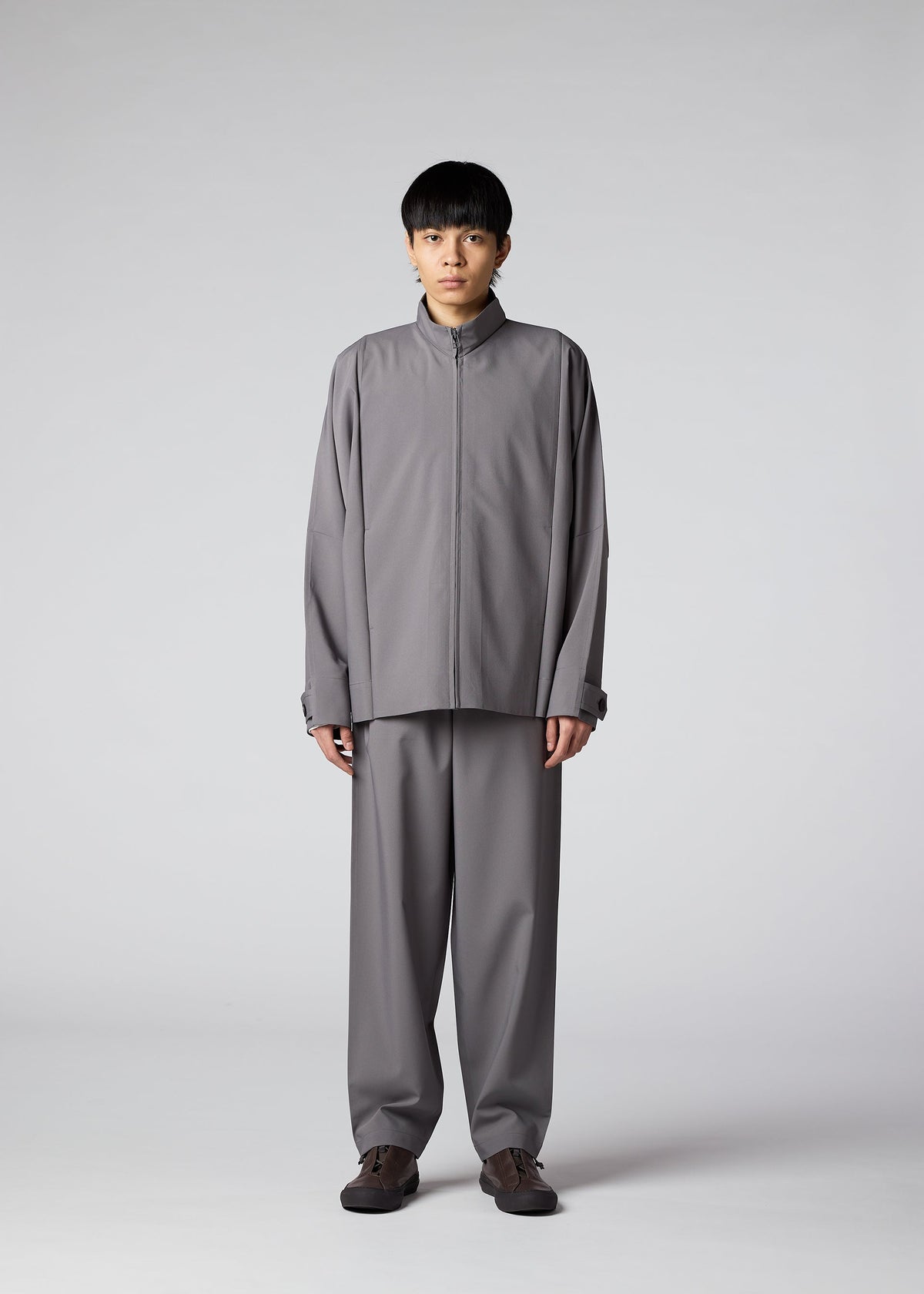 A model wears the IM MEN FLAT clothing.