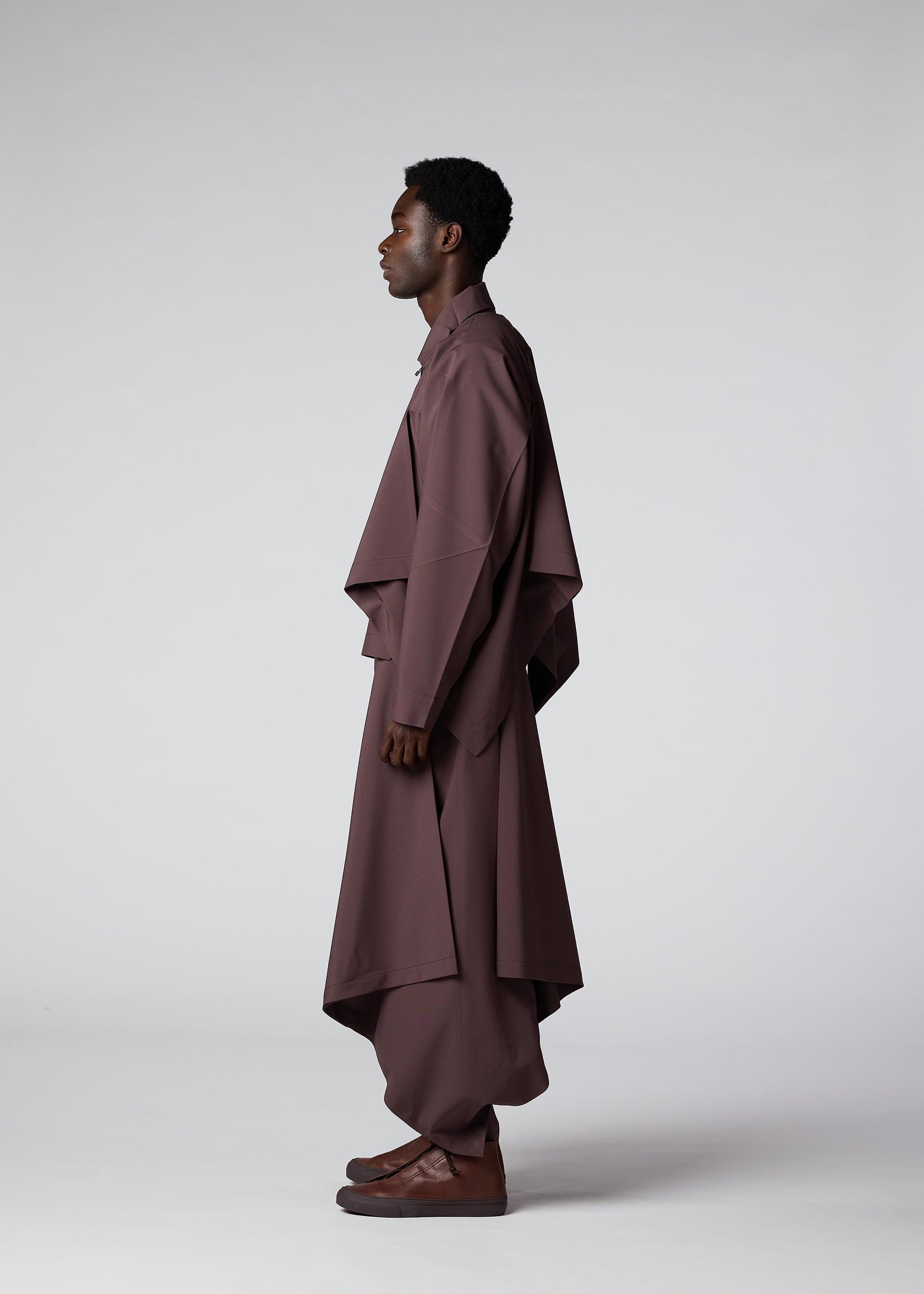 A model wears the IM MEN FLAT DRAPE clothing.