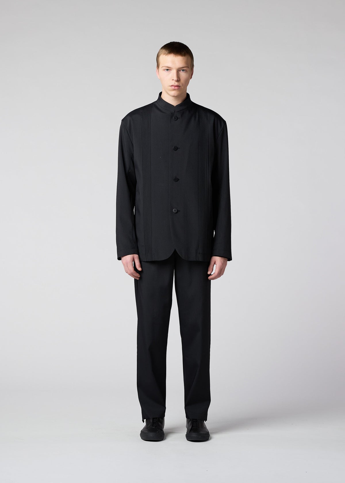 A model wears the IM MEN AIR PLEATS jacket.