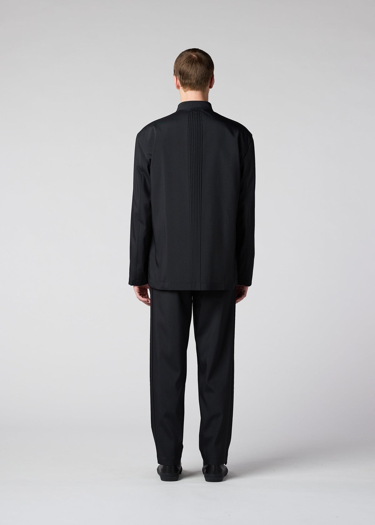 A model wears the IM MEN AIR PLEATS jacket.
