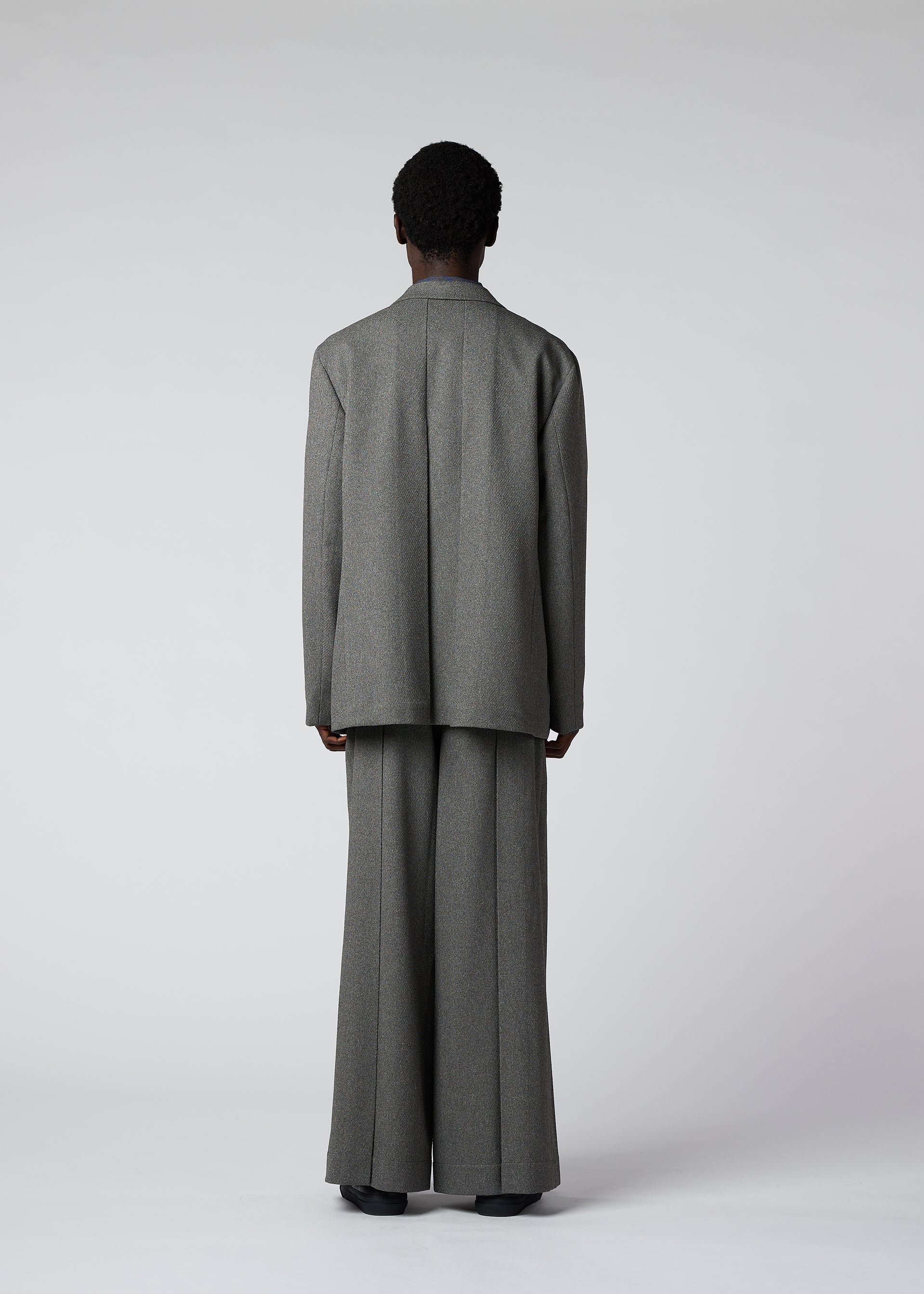 A model wears the IM MEN WOOL LIKE TWEED jacket.