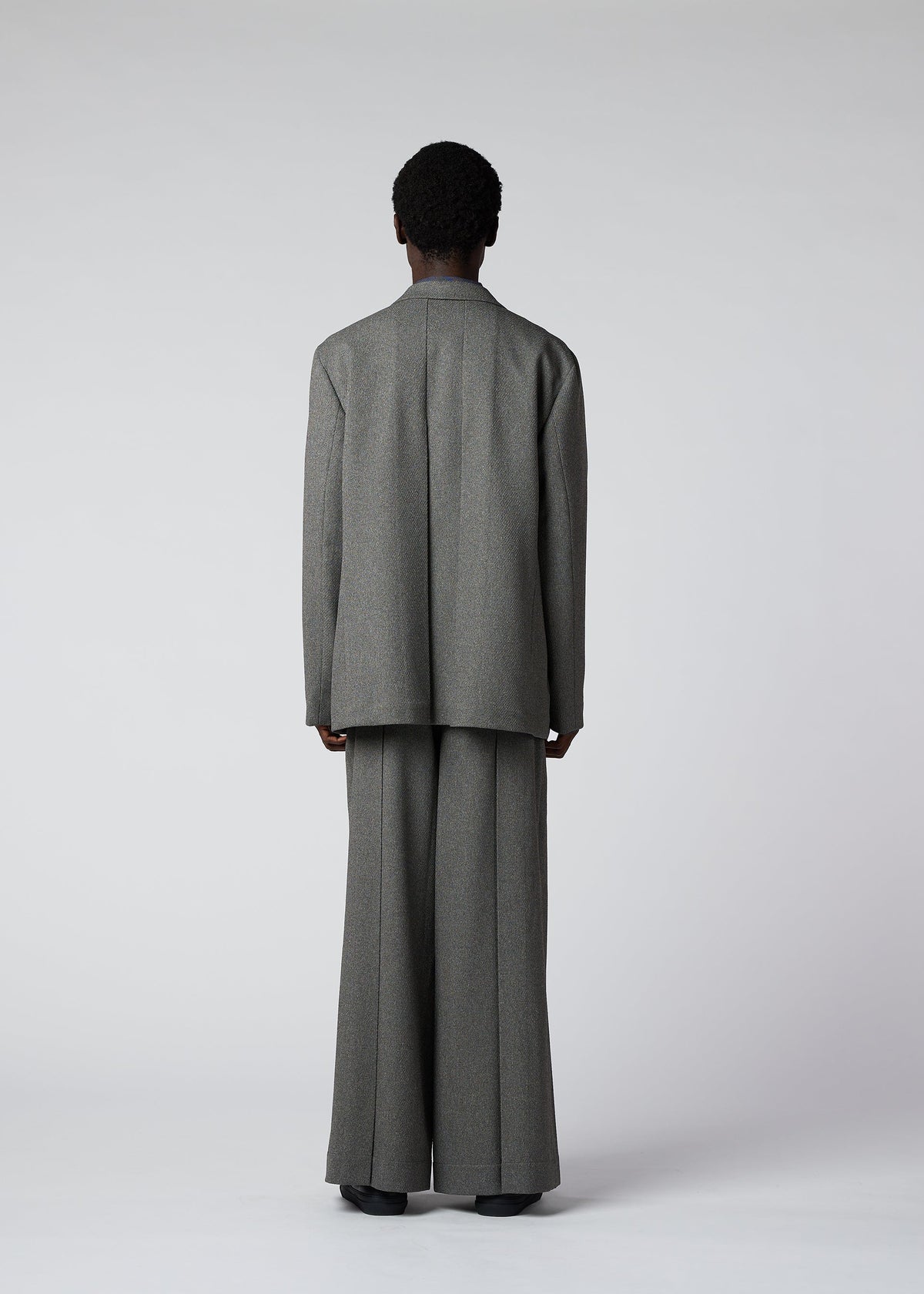 A model wears the IM MEN WOOL LIKE TWEED jacket.