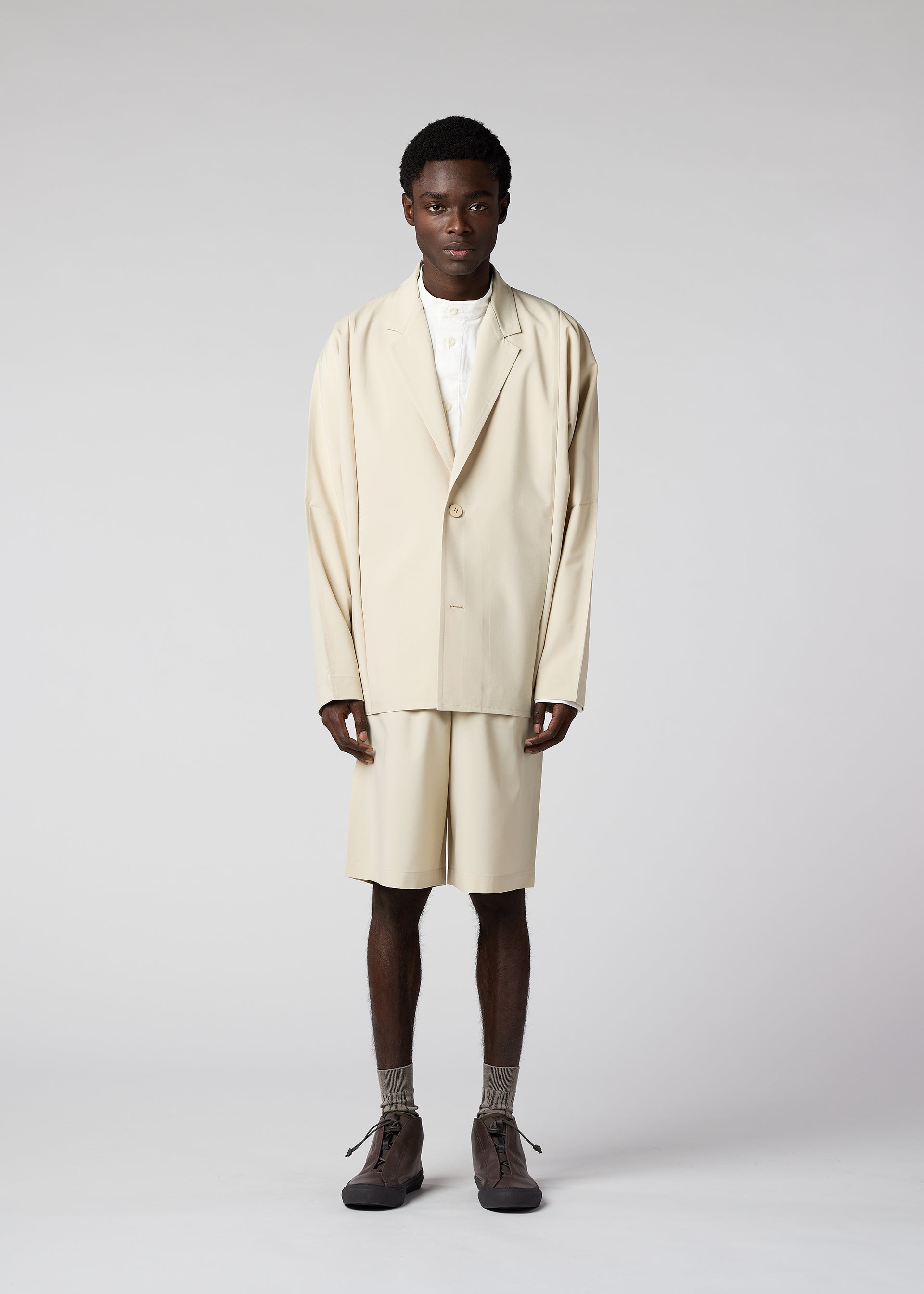 A model wears the IM MEN FLAT clothing.