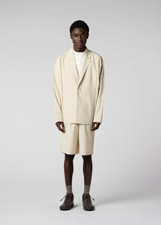 A model wears the IM MEN FLAT clothing.