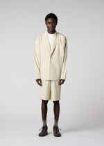 A model wears the IM MEN FLAT clothing.