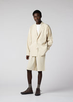 A model wears the IM MEN FLAT clothing.