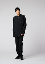 A model wears the IM MEN SHRINK DYE trousers.